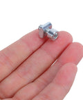 Close-up of single metal unit from 50-Piece M5 Slotted T Nuts Slide-In Kit For Milling Tables And Machine Tools on a hand