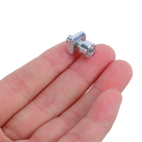 Close-up of single metal unit from 50-Piece M5 Slotted T Nuts Slide-In Kit For Milling Tables And Machine Tools on a hand