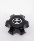 Close-up of Toyota Genuine OEM Wheel Center Cap Sub-Assembly Silver Hub Cover, shiny black finish