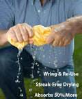 Front view of a man wringing a large 27x17 inch yellow drying chamois for car drying (Absorber by CleanTools)