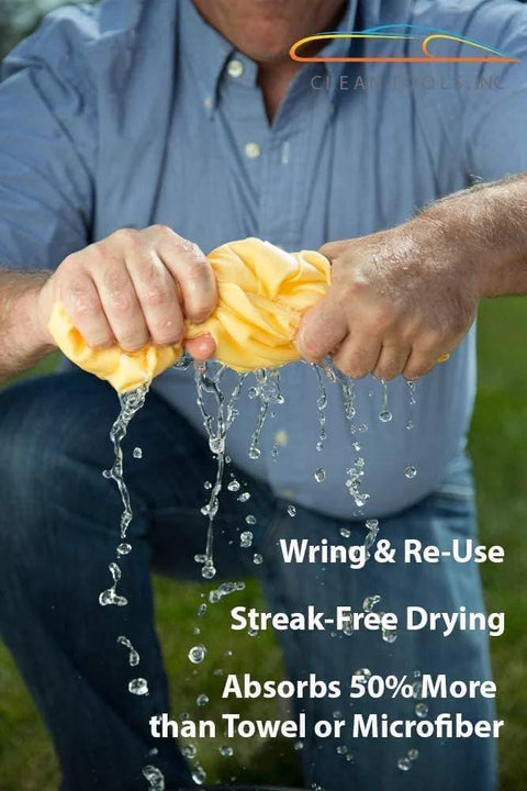 Front view of a man wringing a large 27x17 inch yellow drying chamois for car drying (Absorber by CleanTools)