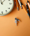 Hidden Desk Drawer Locks With Keys For Office Furniture Sneaky Safe with keys on an orange desk next to a clock and pens.