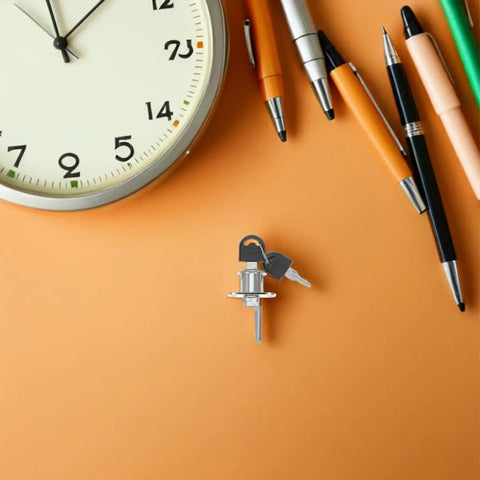 Hidden Desk Drawer Locks With Keys For Office Furniture Sneaky Safe with keys on an orange desk next to a clock and pens.