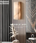 Square Marble Wall Lamp With Wood And Stone Shade in a stylish living room, warm LED glow, modern rustic decor.