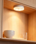 4 Pack Rechargeable Puck Lights With Remote And Touch Control, brightening wooden kitchen shelf, highlighting dishes