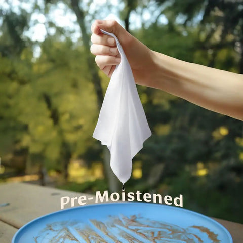 Hand holding Rinse Free Dish Wipes For Camp Kitchens That Are Biodegradable And Pre Moistened With Food Safe Formula Perfect For Quick Cleanup