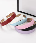 Wide 1 Inch Ultra Soft PU Leather Headband For Women Girls Comfortable Padded Faux Hair Band in various colors stacked.