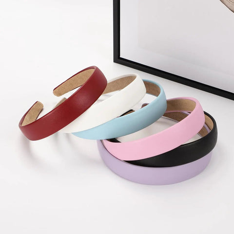 Wide 1 Inch Ultra Soft PU Leather Headband For Women Girls Comfortable Padded Faux Hair Band in various colors stacked.
