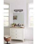 Three-Light Coastal Bath Vanity Light With Clear Glass, Rustic X-Brace Design, installed above a bathroom mirror.