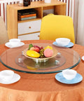 Transparent Tempered Glass Lazy Susan Turntable 40 Inch Large Rotating Tray on a dining table with fruit bowl and cups
