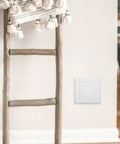 Sleek 3X3 Inch White Drywall Access Panel For Bathroom Plumbing Maintenance Durable Pvc Wall Cover Plate, seen on wall with decorative ladder.