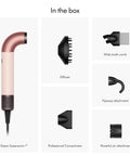 Supersonic Hair Dryer In Ceramic Pink And Rose Gold For Ultrafast Drying Lightweight Ergonomic Design With No Heat Damage And Smoother Styling Anywhere Like A Salon Session At Home, shown with attachments in box
