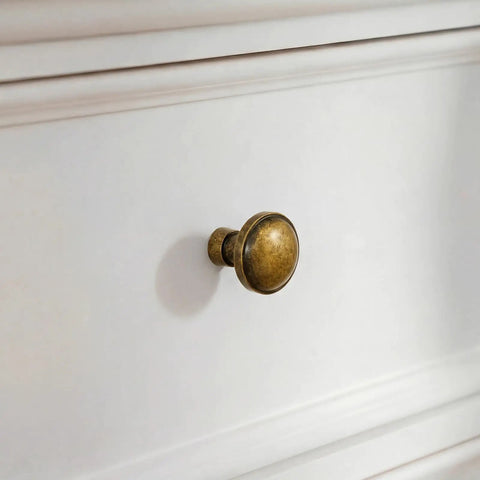 Vintage Antique Brass Cabinet Knobs And Drawer Handles 1 1/4 Inch on a white dresser, showcasing solid zinc alloy construction.