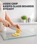 Rock Solid Clear Silicone Anti Slip Pads For Glass Tables And Desks With Zero Slide Grip and Protective Two Millimeter Cushion To Keep Furniture Locked Down In A Slick Thirty Six Pack used on a glass cutting board with sliced lemons.