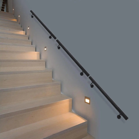 Rock Solid Heavy Duty Wall Mounted Stair Handrail Featuring Matte Black Stainless Steel Cylinder Rods For Killer Grip And Effortless Home Installation Projects on wooden stairs with lights.
