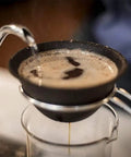 Pouring hot water through Prime Pick Japanese Ceramic Coffee Dripper With Reusable Filter for brewed coffee.