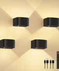 4 Pack Motion Sensor Wall Lamps With Remote, Three Color Modes, Wireless LED Indoor Up And Down Wall Sconce in Black, shown with USB cables and remote.