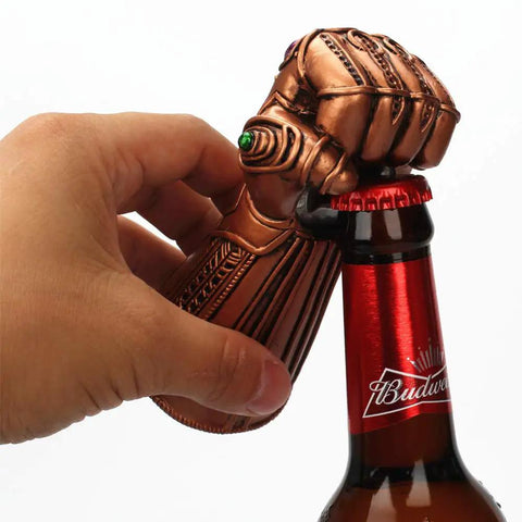 Infinity Gauntlet Bottle Opener Multipurpose Party Tool For Home Use Dope Thanos Style Resin And Metal Construction With Copper Finish Glass Cap Remover Beer And Soda Bottle Topper Gadget For Kitchen And Bar being used on a bottle