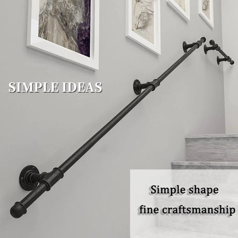 Black Wrought Iron Stair Handrail Wall Mounted Indoor Outdoor Support Bar With Kickass Ergonomic Grip Built Tough For Daily Use Senior Safety Adjustable Length Weather Resistant on gray wall with framed art.