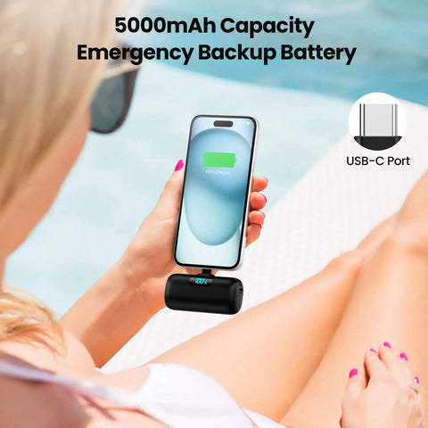 Person using Compact USB C Power Bank With Built In USB C Connector 5000mAh PD Fast Charging Battery Pack on iPhone outdoors.
