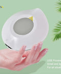 Real Deal USB Coffee Warmer Keeps Your Daily Brew Piping Hot Or Ice Cold All Day Long Universal Mug Heater Cooler Plate Fits Any Cup Style smooth electric coaster held in hand against a green background.