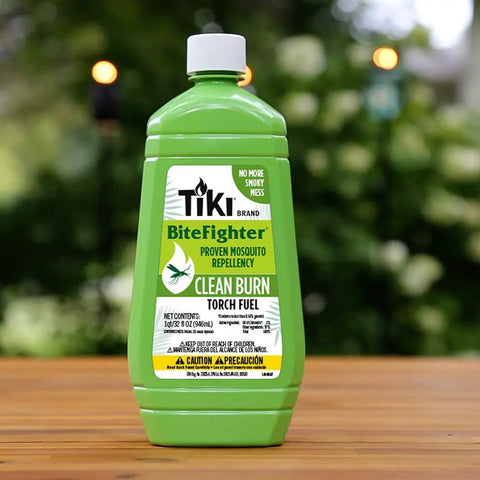 Clean Burn Mosquito Repellent Torch Fuel For Outdoor Use Easy Pour One Quarter Gallon 32 Oz Smokeless Low Soot Citronella Plant Based Formula Works With All Torches Patio Garden Backyard green bottle on wooden surface