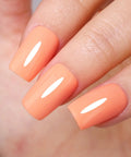 Close-up of nails painted with Coral Orange Gel Nail Polish 10ml HEMA Free UV LED Cure Soak Off Long Lasting Summer Formula