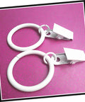 Two white metal curtain rings with clips from the Metal Curtain Rings With Clips Set 10 Pack Heavy Duty Design For Smooth Glide On Curtain Rods Fits Bathroom Bedroom Living Room Electroplated Modern Finish For Durable Hanging And Easy Shower Curtain Setup.