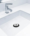 Rubber Bathtub Drain Plug with Stainless Steel Easy Pull-Out Stopper in a white sink with a modern faucet.