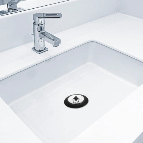 Rubber Bathtub Drain Plug with Stainless Steel Easy Pull-Out Stopper in a white sink with a modern faucet.