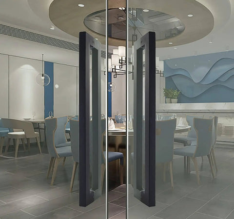 Stainless Steel Dope Push Pull Door Handle Set Black Matte Square Barn Style installed on glass doors in a modern dining room