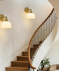 Feasey Vintage Milk Glass Globe Wall Sconce, Mid Century Ribbed Glass Light on a curved staircase wall.
