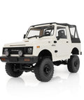 White RC model inspired by Suzuki Jimny JA11 4x4 truck, featuring durable ABS body, leaf spring suspension & LED lights, 1/10 scale.