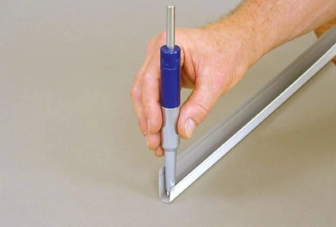 Hand using 8 Inch Blue Heavy Duty Trim Nail Punch for Soffit, Fascia, and Finishing Trim, Steel Nose, Aluminum Tail, Drives 1-1/4 Inch Nails
