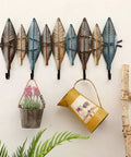 Hella Sturdy Wall Mounted Coat Rack With Reinforced Hooks For Clothes Hats And Robes Totally Multipurpose Entryway Organizer showcasing leaf-shaped hooks with potted plants attached.