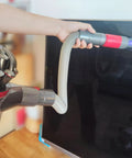 Person using the 3-In-1 Vacuum Attachment Bundle with 23 inch flexible crevice tool on a screen