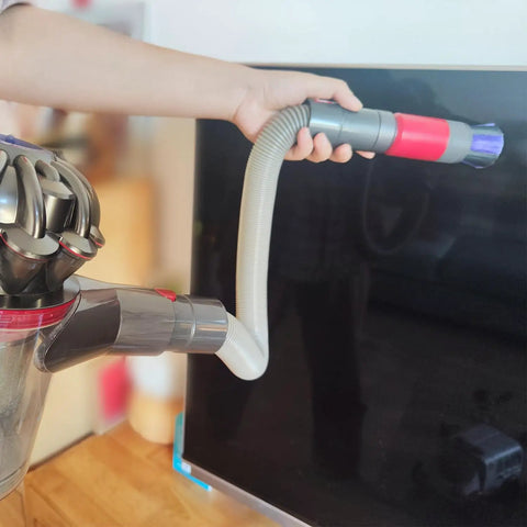 Person using the 3-In-1 Vacuum Attachment Bundle with 23 inch flexible crevice tool on a screen