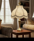 Off White Jacquard Scallop Bell Lamp Shade With Fringes, Spider Construction displayed on table in elegant living room