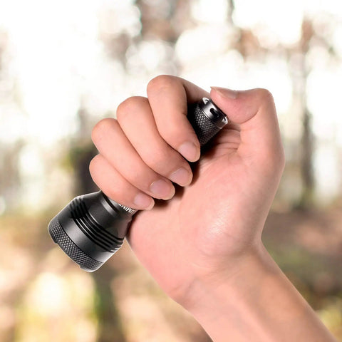 Hand holding Pocket Thrower GTA LED Flashlight That Hits Hard With Ultra Long Throw, 1919 ft Beam, 85000cd, compact design