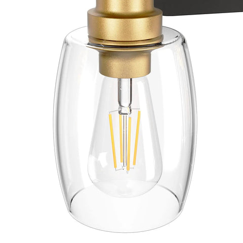 Close-up of Two Light Sleek Industrial Black And Gold Vanity Light Fixture Over Mirror With Clear Glass Shades, E26 socket visible