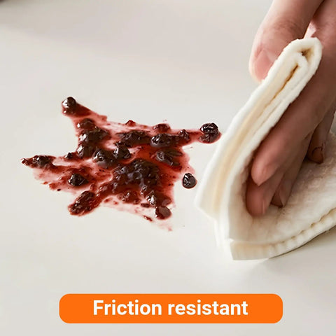 Hand cleaning a surface with jam using a cloth while highlighting friction resistant feature.