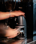 Electric Auto Leveling Espresso Tamper For 57.3 Mm Portafilters in action, tamping with consistent pressure, ideal for baristas.
