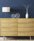 Dang Sharp Black And White Marble Look Round Cabinet Knobs 4 Pack on a wood dresser with soft lamp and decor items.
