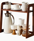 Natural Bamboo Coffee Station Organizer, 2-Tier Wooden Counter Shelf For Bar Gear And Syrup Bottles, Must-Have Kitchen Storage Rack For Coffee Essentials, Durable Dark Brown Finish with mugs and kettle displayed