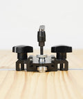 Front view of Pro Grade Aluminum T Track Positioning Jig for Woodworking on wooden surface with adjustable knobs visible