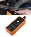 Universal Car TPMS Relearn Tool For Tire Pressure Sensor Activation And Reset, Built Tough Abs Housing in hand near tire.