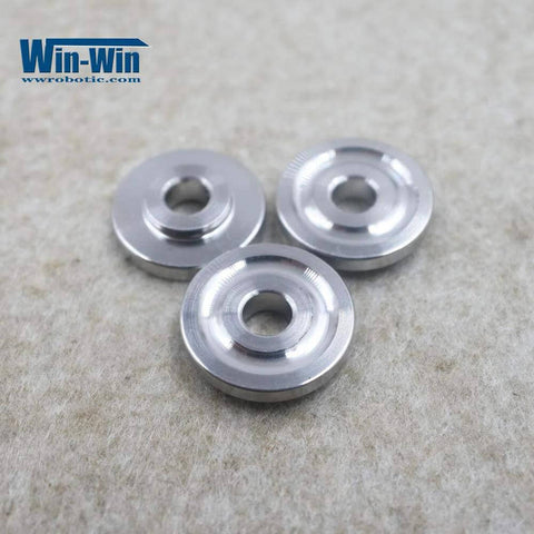 Three Win-Win silver metal inlet poppet parts with central bore for waterjet direct-drive pump.