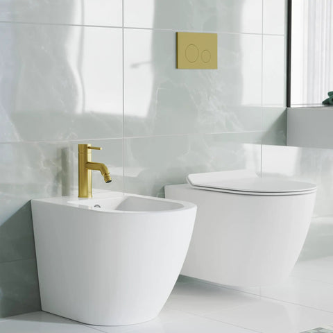 Ivy Bidet Faucet Brushed Gold Solid Brass Build Easy One Hole Install 1.2 GPM Flow Single Handle Hot Cold Control slick modern bath fixture next to a white toilet in a stylish bathroom.