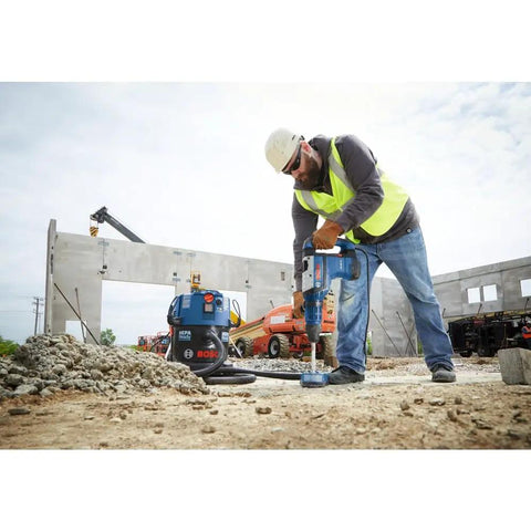 Worker using SpeedXtreme SDS Max Rotary Hammer Drill Bit 1 In Diameter With 100 Percent Carbide Head And Four Cutter Design