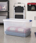 66 Quart Clear Plastic Storage Bin With Secure Blue Latch Lids Stackable Home Organization Tote For Garage Closet And Pantry, filled with stacked blankets.